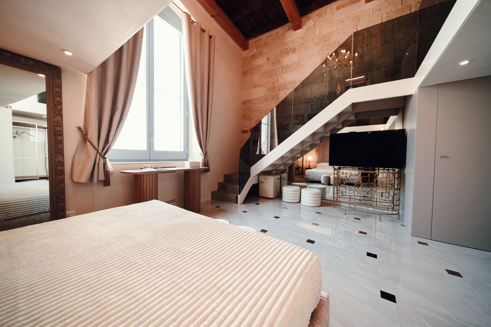 Towards the window and the stairs.