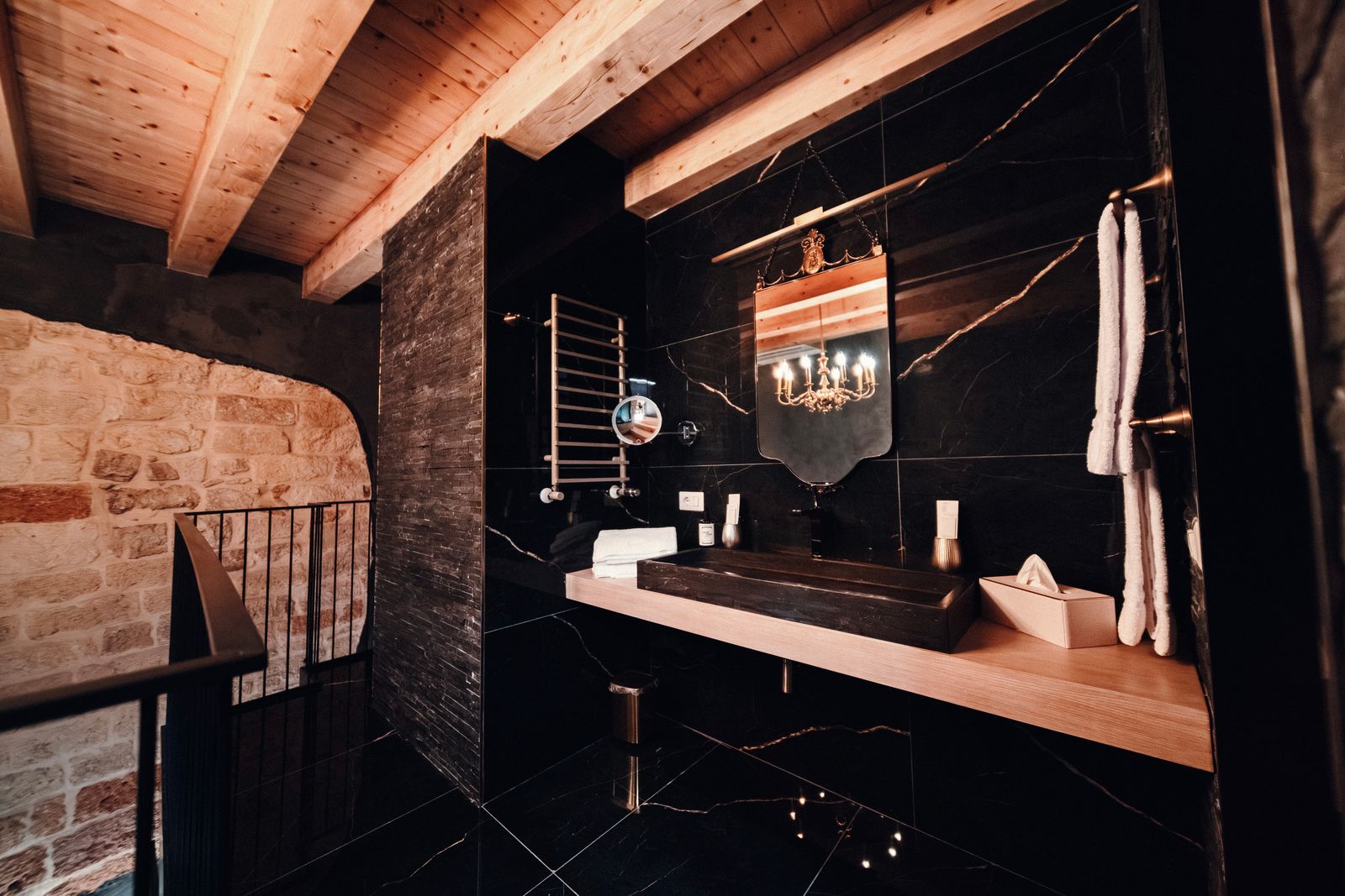 The black stone basin beneath the beams.
